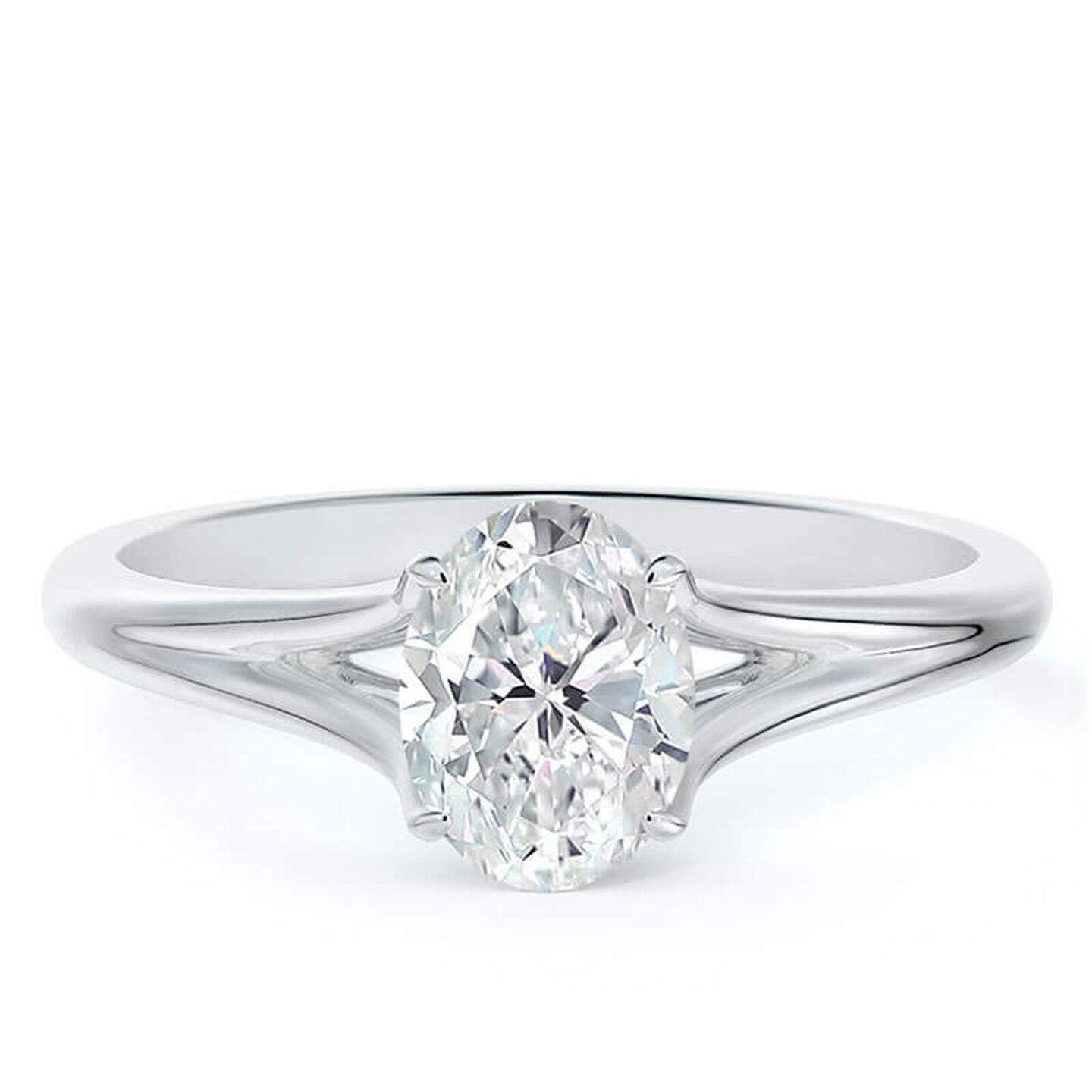 An oval diamond solitaire ring in white gold on a white surface