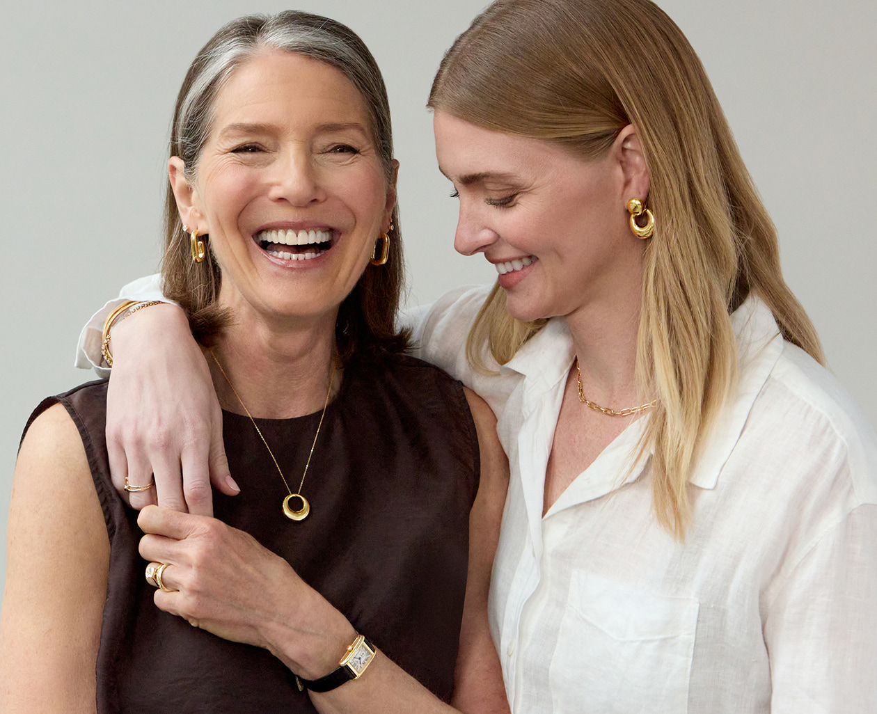 A mother and daughter embracing and smiling